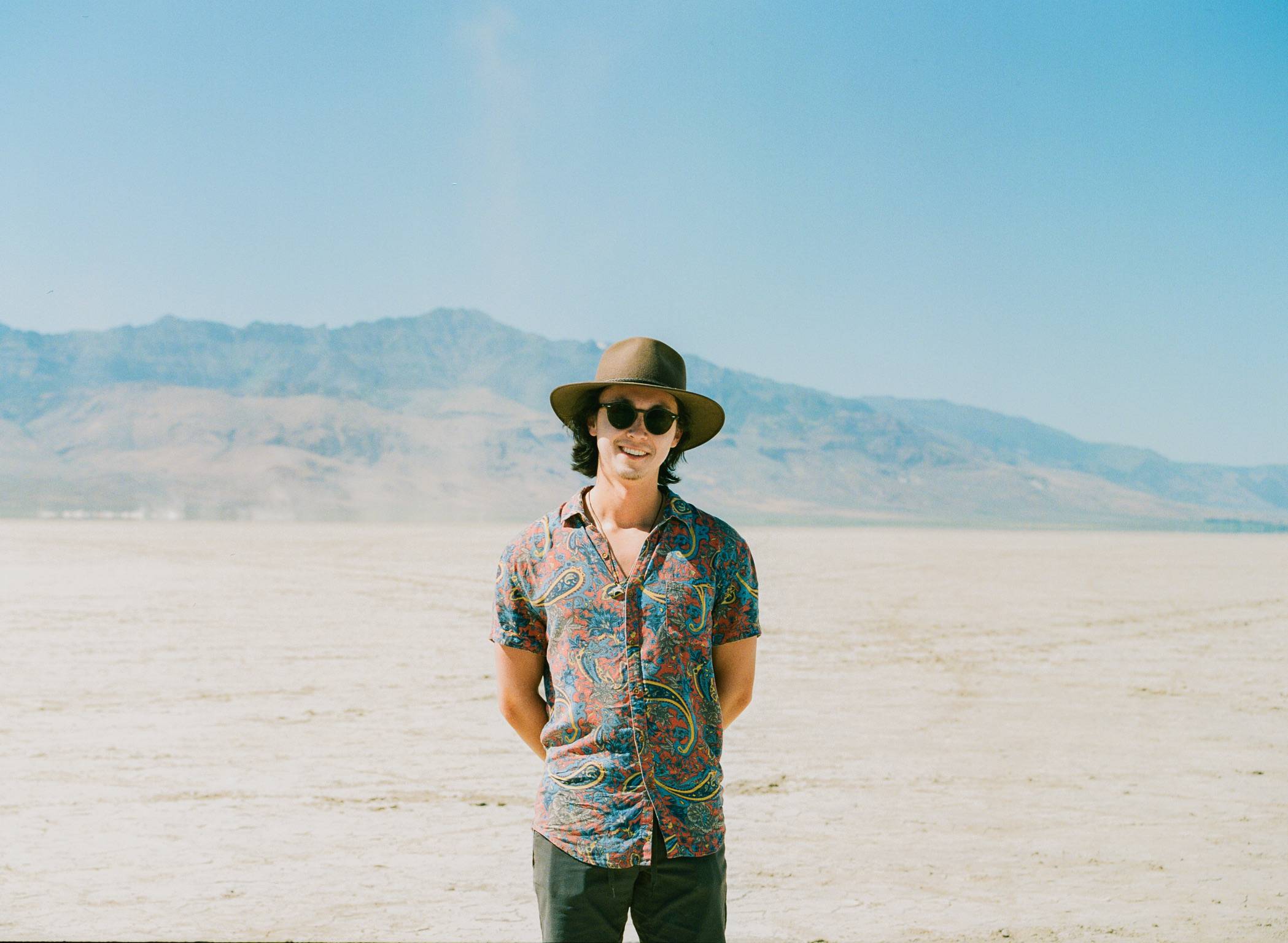 Cody Mitchell standing on a desert playa